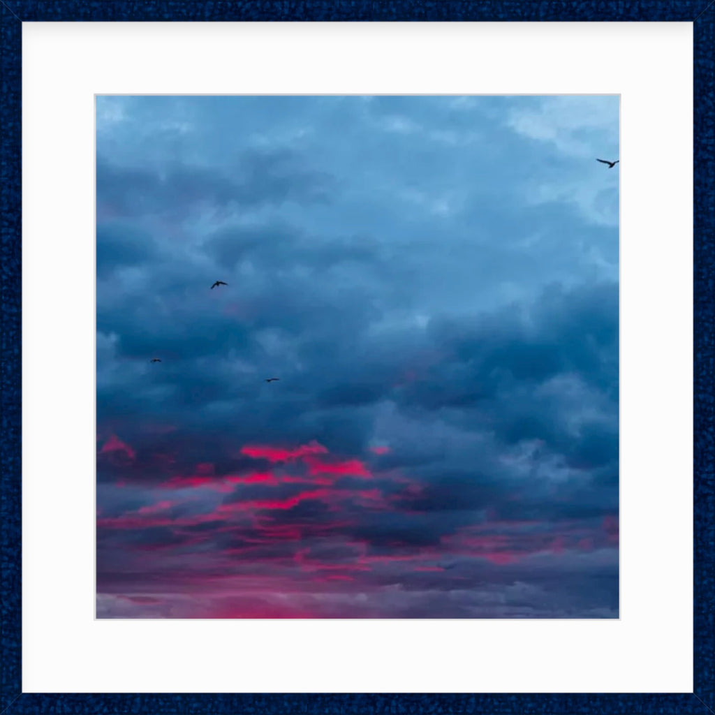 Framed Picture Of Birds Flying Above Deep Red Clouds