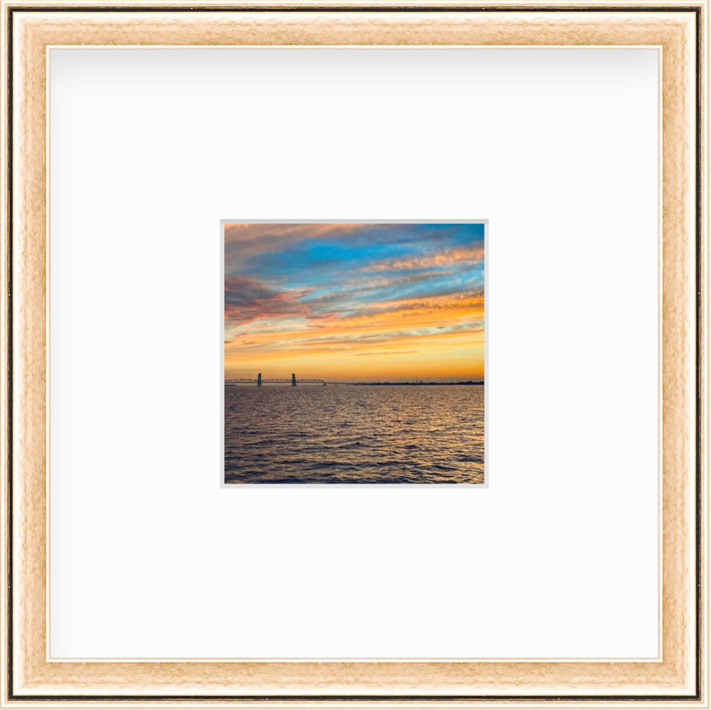 Framed Picture Of A Blue And Orange Sky Above Water