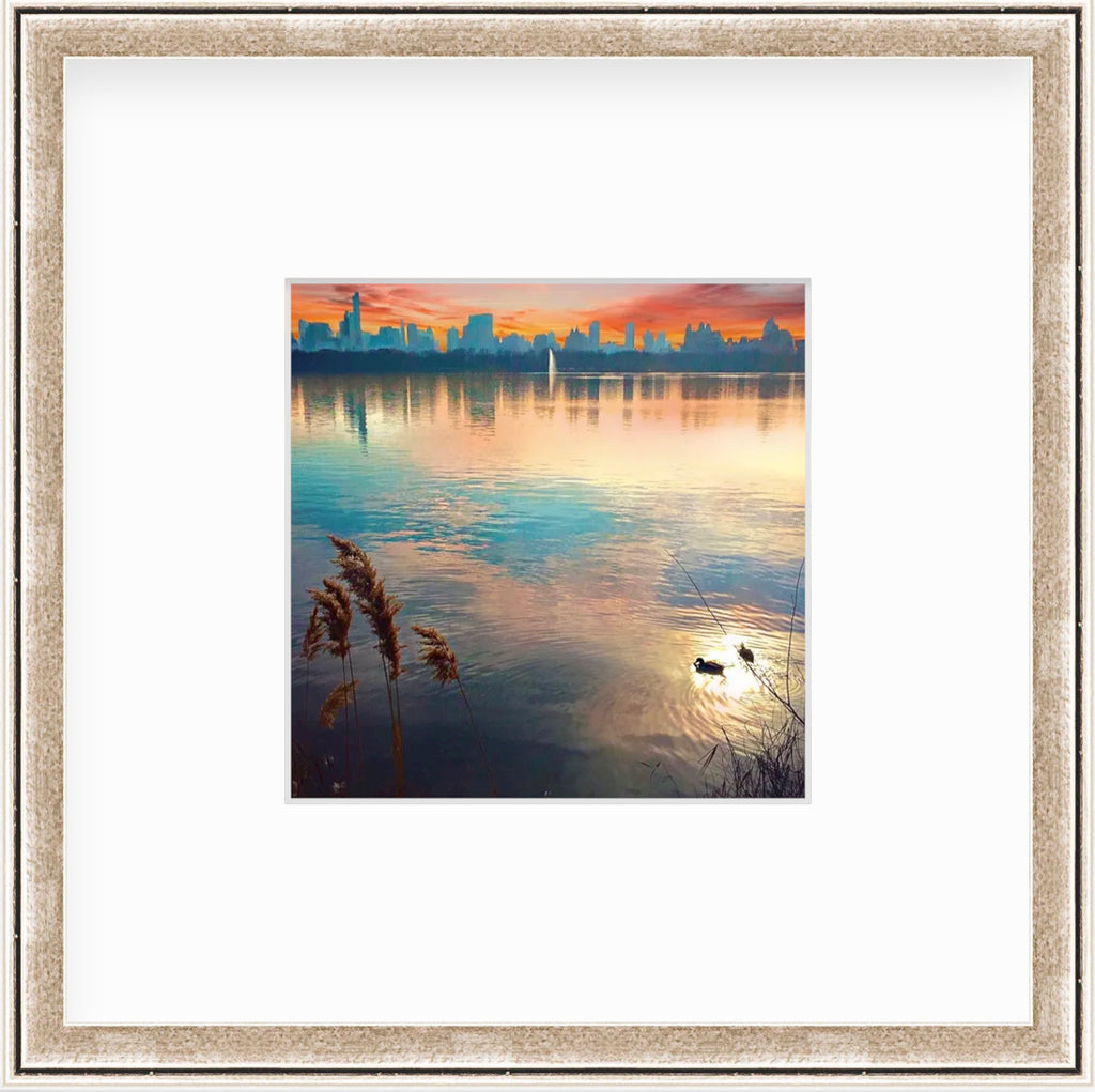 Framed Picture Of A City Skape And Orange Sunset Across Water