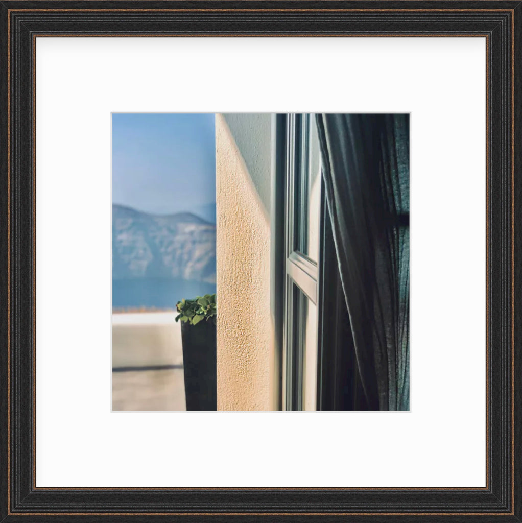 Framed Picture Of A Mountain In The Distance Behind An Open Doorway