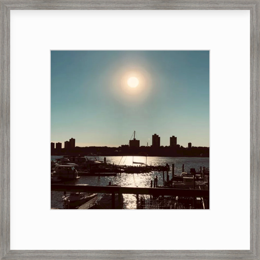 Framed Picture Of A City Scape Behind Water At Sunset