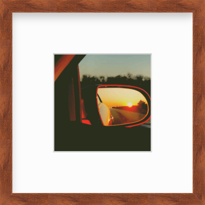 Framed Picture Of A Sunset In A Car's Rear View Mirror
